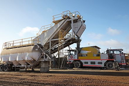 A Redpath agitator machine getting filled with raw materials.